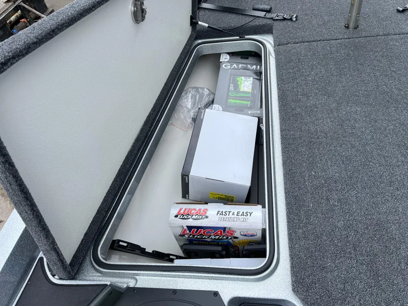 Slide: The Image of 2024 Ranger Z518 storage compartment with Garmin equipment and Lucas Oil products. - 18