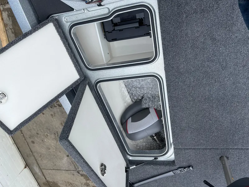 Slide: The Image of 2024 Ranger Z518 Garmin Ranger Cup boat storage compartments with open lids. - 19