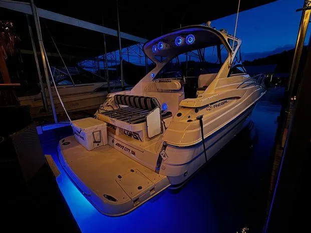 Slide: The Image of 2006 Regal Commodore 3760 IO boat with blue LED lights at night. - 24