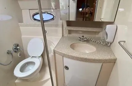 Slide: The Image of Bathroom interior of 2006 Regal Commodore 3760 IO yacht, featuring toilet and sink. - 29