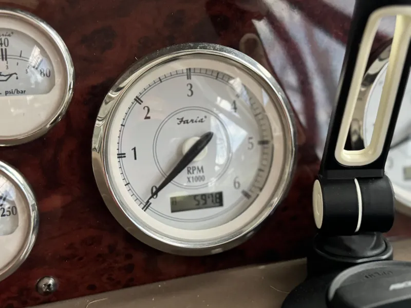 Slide: The Image of RPM gauge of 2006 Regal Commodore 3760 IO boat dashboard, showing 591.8 hours. - 34