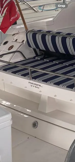 Slide: The Image of 2006 Regal Commodore 3760 IO boat with striped seating and flag. - 42