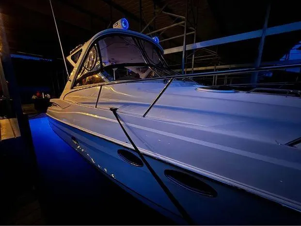 Slide: The Image of 2006 Regal Commodore 3760 IO boat illuminated in a dimly lit marina setting. - 5
