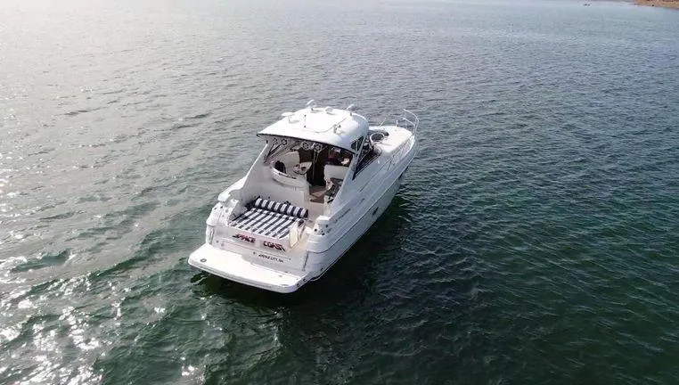 Slide: The Image of 2006 Regal Commodore 3760 IO boat cruising on open water, aerial view. - 6