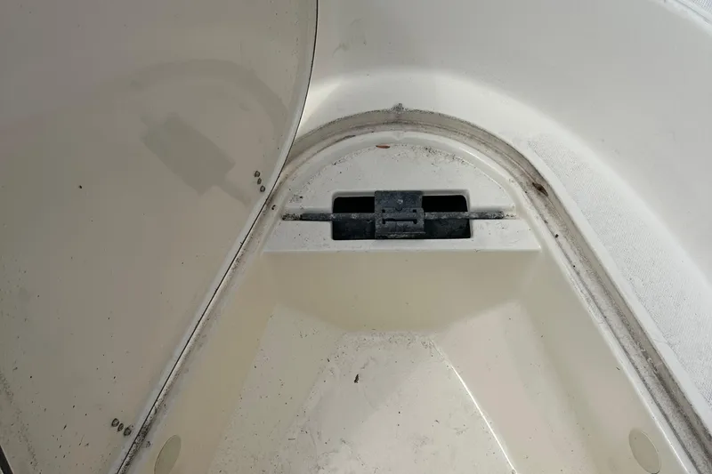 Slide: The Image of Open storage compartment in a 2002 Sea Hunt 172 boat, showing interior details. - 10