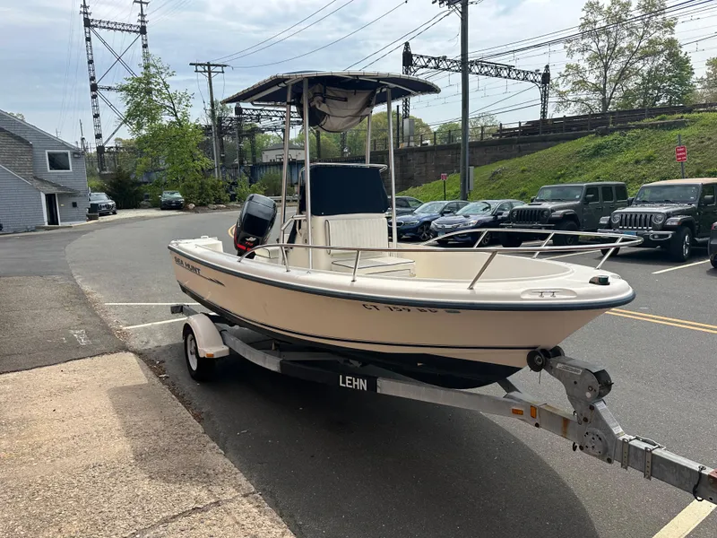 Slide: The Image of 2002 Sea Hunt 172 boat on trailer parked on street, ready for transport. - 3