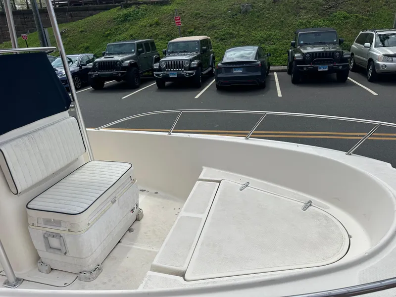 Slide: The Image of 2002 Sea Hunt 172 boat interior with seating, parked cars in background. - 4