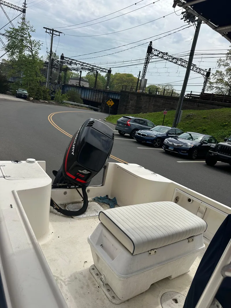 Slide: The Image of 2002 Sea Hunt 172 boat with outboard motor, parked on a street near a railway bridge. - 5