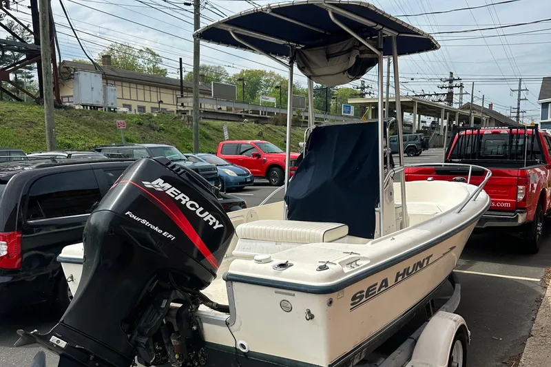 Slide: The Image of 2002 Sea Hunt 172 boat with Mercury outboard motor, parked in a lot. - 7