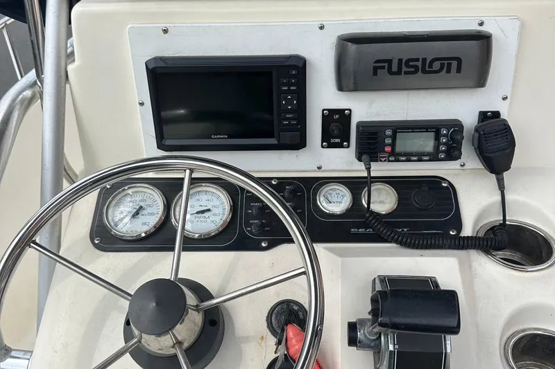Slide: The Image of Control panel of a 2002 Sea Hunt 172 boat with steering wheel and gauges. - 9
