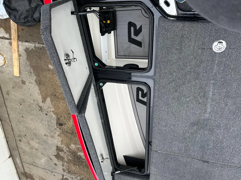 Slide: The Image of 2024 Ranger Z521 RC boat storage compartments with open lids, showcasing interior design. - 11