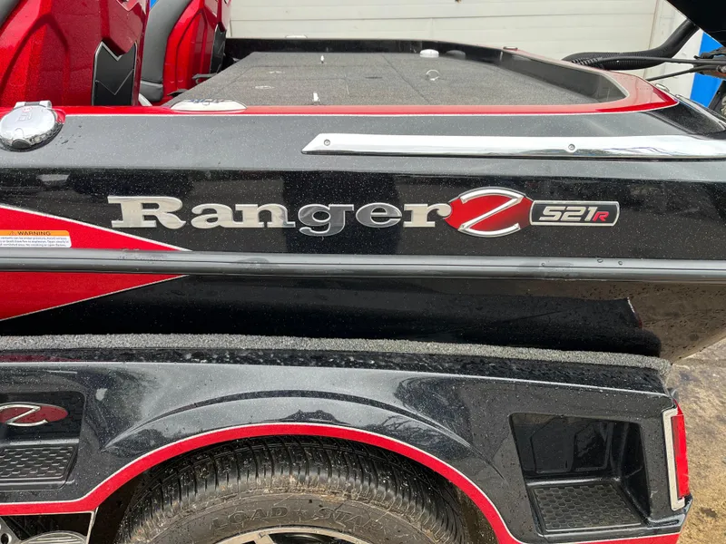 Slide: The Image of 2024 Ranger Z521 RC boat with red and black detailing, side view. - 15