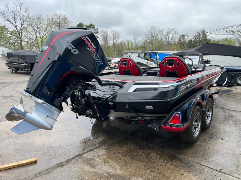 Slide: The Image of 2024 Ranger Z521 RC boat with powerful outboard motor, parked outdoors on a cloudy day. - 3