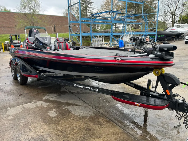Slide: The Image of 2024 Ranger Z521 RC boat on trailer, black and red design, parked outdoors. - 4