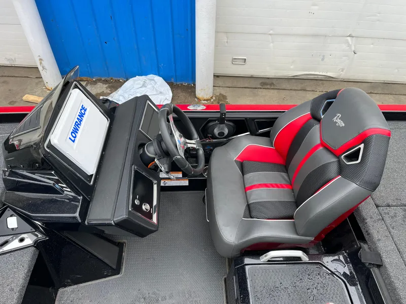 Slide: The Image of 2024 Ranger Z521 RC boat interior with red and black seating and Lowrance electronics. - 7