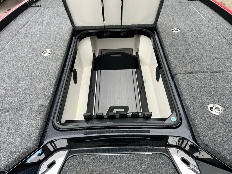 Slide: The Image of 2024 Ranger Z521 RC boat storage compartment with open lid, showcasing spacious interior. - 9