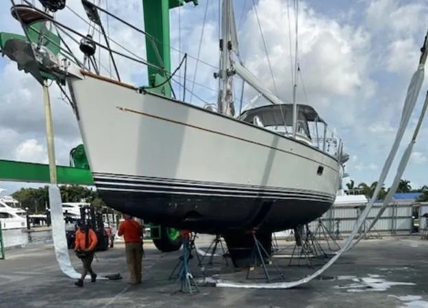 Slide: The Image of Sailboat Passport 545 Vista 2014 in dry dock for maintenance, with workers nearby. - 22