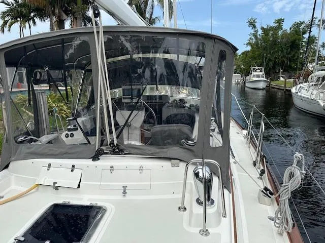 Slide: The Image of Sailboat docked in a marina, Passport 545 Vista, 2014 model, with covered cockpit. - 24
