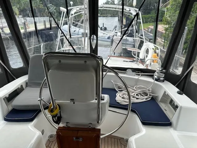 Slide: The Image of 2014 Passport 545 Vista yacht cockpit with steering wheel and seating area. - 26