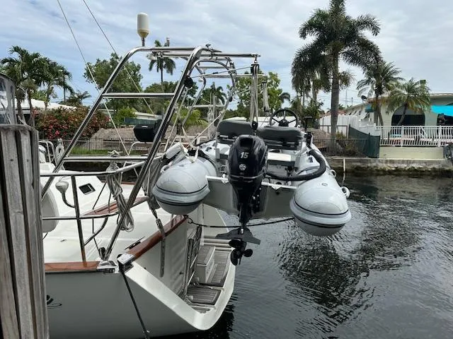 Slide: The Image of Sailboat docked with dinghy attached, Passport 545 Vista, 2014 model, tropical setting. - 35