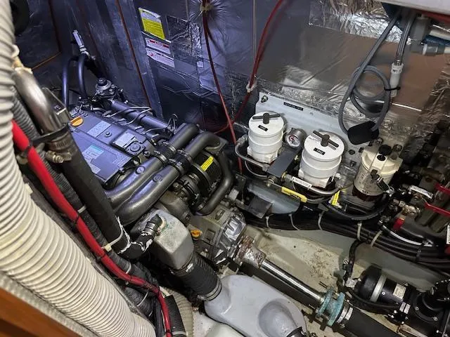 Slide: The Image of Engine room of 2014 Passport 545 Vista yacht, showcasing mechanical components and wiring. - 37