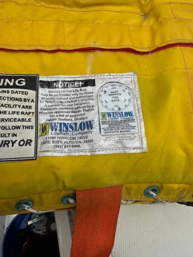 Slide: The Image of Yellow Winslow life raft label with service instructions and contact information. - 40