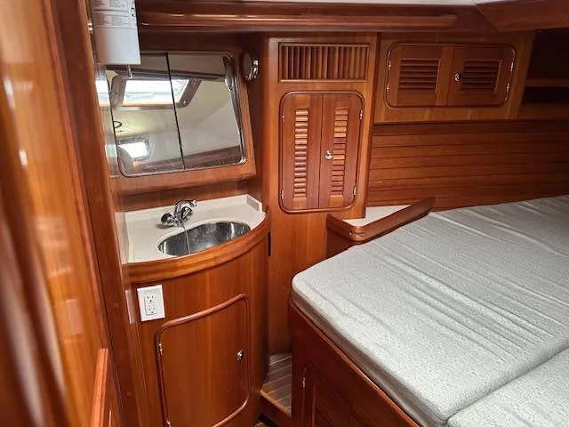Slide: The Image of Luxurious 2014 Passport 545 Vista yacht interior with wood finish, sink, and bed. - 5