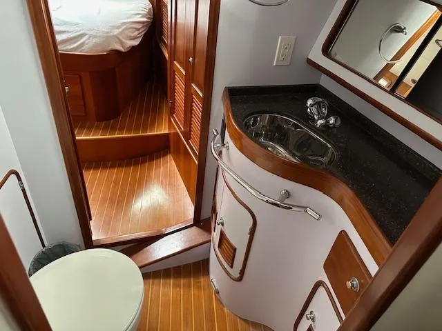 Slide: The Image of Luxurious bathroom in 2014 Passport 545 Vista yacht with wood accents and modern fixtures. - 8