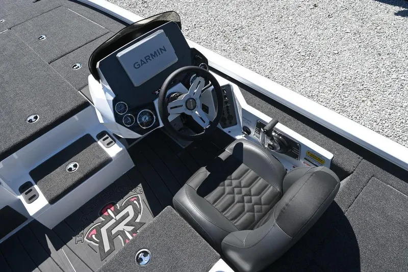 Slide: The Image of 2025 Vexus AVX 1980 boat cockpit with Garmin display and black seating. - 12