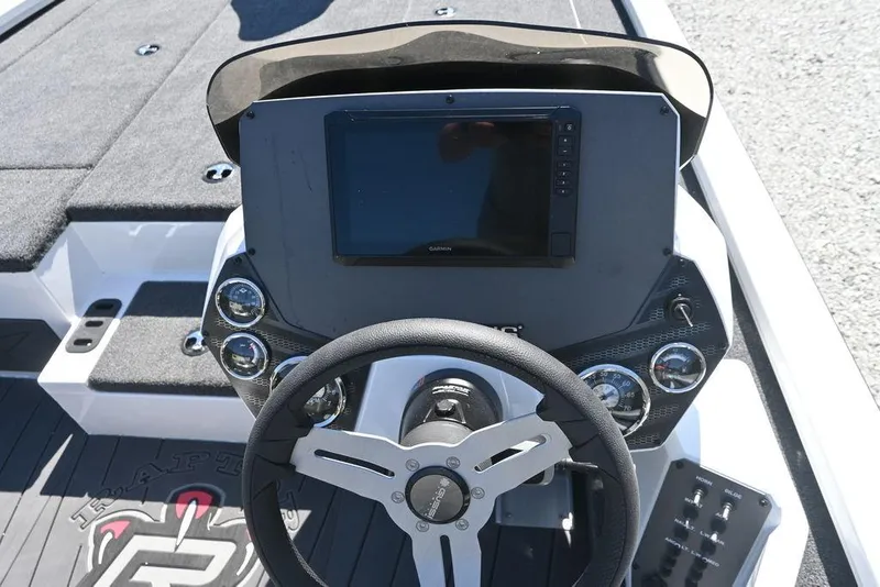 Slide: The Image of 2025 Vexus AVX 1980 boat dashboard with steering wheel and electronic display. - 13