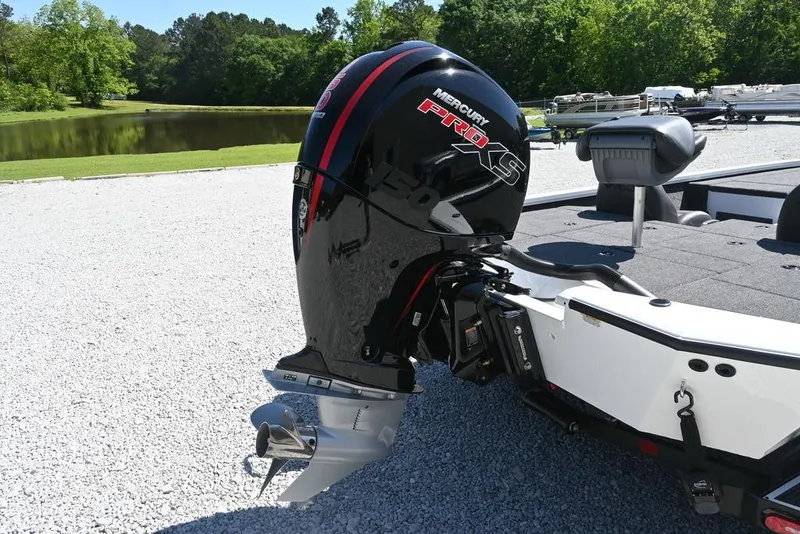 Slide: The Image of 2025 Vexus AVX 1980 boat with Mercury Pro XS engine, parked near a lake. - 5