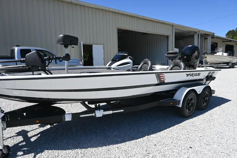 Slide: The Image of 2025 Vexus AVX 1980 boat on trailer, parked outside a warehouse. - 6