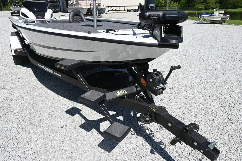 Slide: The Image of 2025 Vexus AVX 1980 boat on trailer, parked on gravel, featuring sleek design and modern equipment. - 7