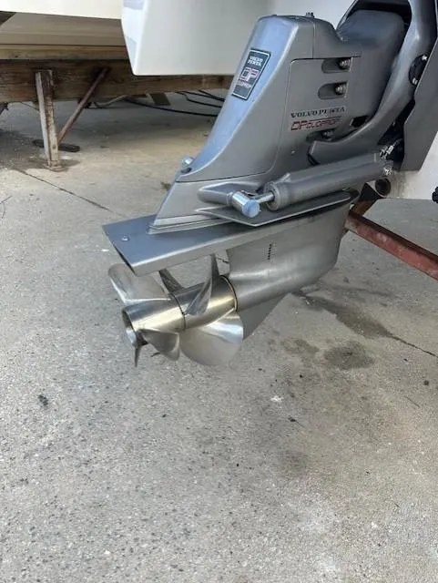 Slide: The Image of 1998 Four Winns 225 Sundowner boat propeller and outdrive on concrete surface. - 11