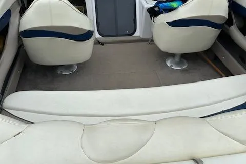 Slide: The Image of Interior of a 1998 Four Winns 225 Sundowner boat with white seating. - 12