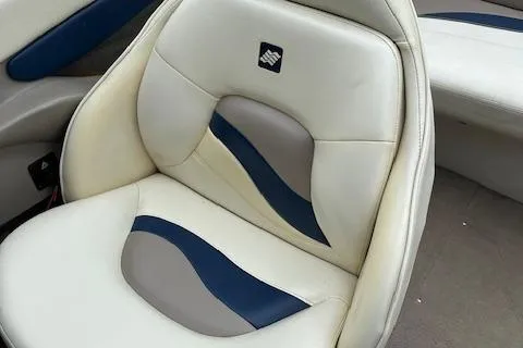 Slide: The Image of 1998 Four Winns 225 Sundowner boat seat with white, gray, and blue upholstery design. - 13