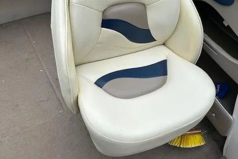 Slide: The Image of 1998 Four Winns 225 Sundowner boat seat with white and blue upholstery. - 14