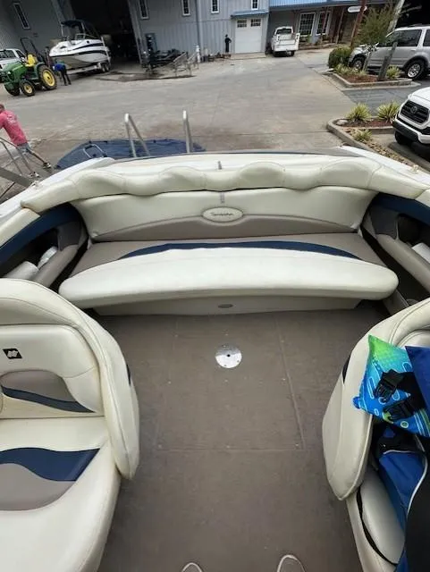 Slide: The Image of 1998 Four Winns 225 Sundowner boat interior with white seating and blue accents. - 7