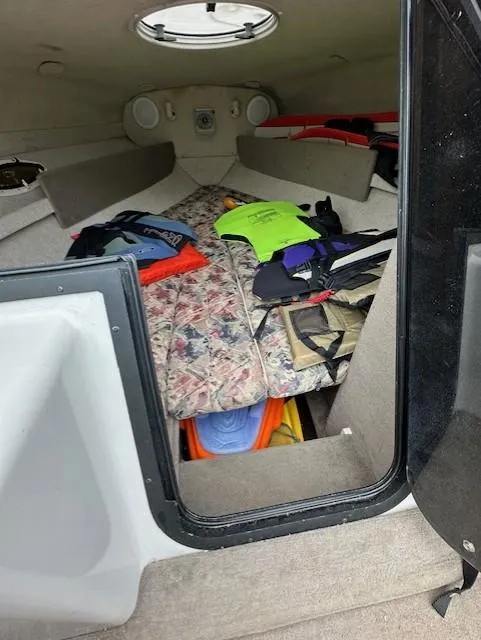 Slide: The Image of Interior cabin of a 1998 Four Winns 225 Sundowner with life jackets and gear. - 8