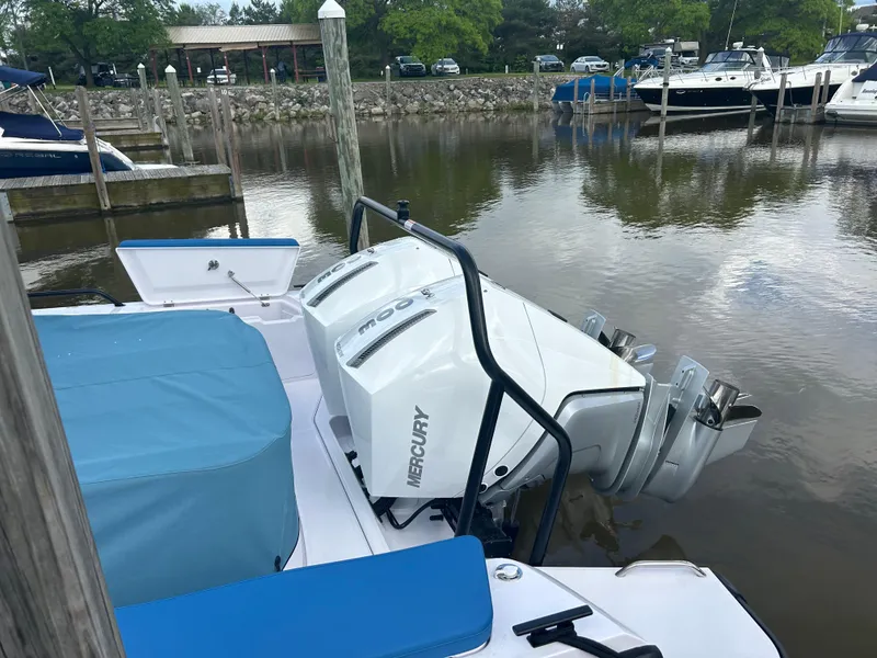 Slide: The Image of 2024 Axopar 37 XC Cross Cabin with Mercury outboard engines docked at marina. - 6