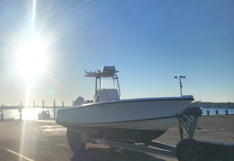 Slide: The Image of 2005 Contender 23 Tournament boat on trailer at sunny waterfront. - 1