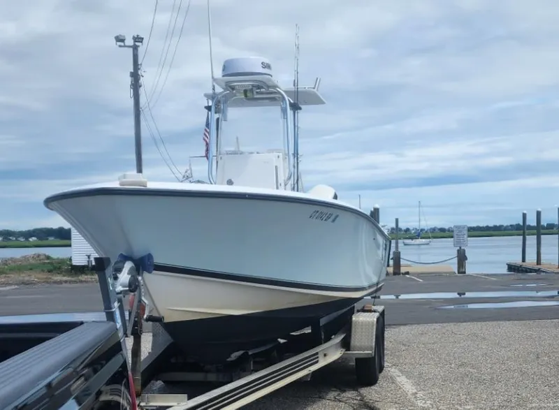 Slide: The Image of 2005 Contender 23 Tournament boat on trailer at a dockside location. - 2