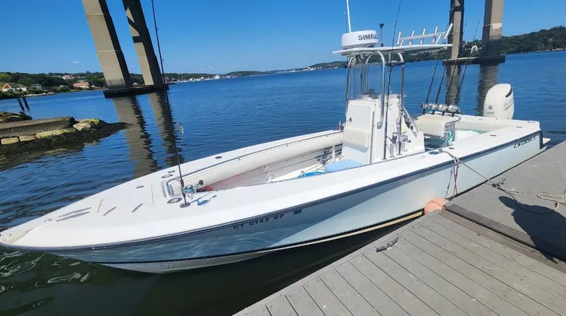 Slide: The Image of 2005 Contender 23 Tournament boat docked by a bridge on a sunny day. - 4