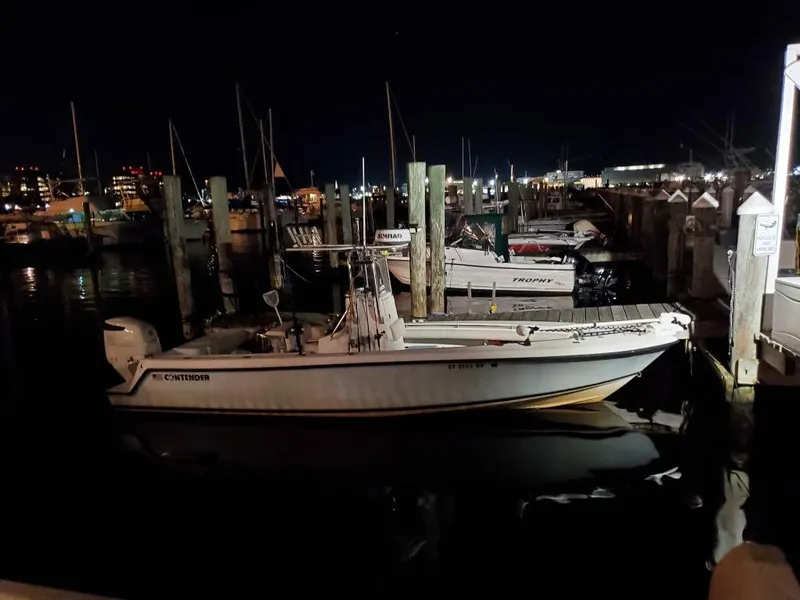 Slide: The Image of 2005 Contender 23 Tournament boat docked at night in a marina. - 6