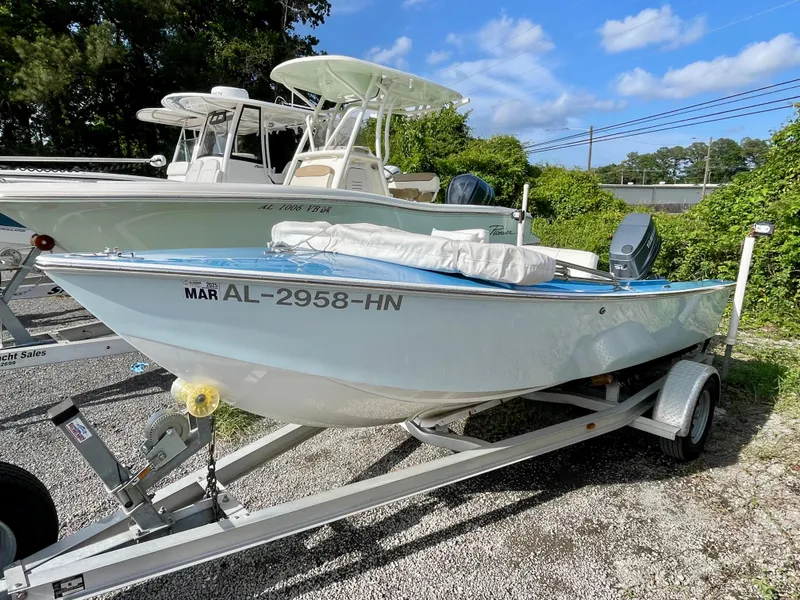Slide: The Image of 1979 Negus 17 boat on trailer, parked outdoors under blue sky. - 0