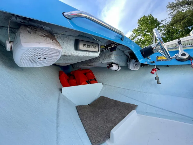 Slide: The Image of Interior of a 1979 Negus 17 boat with speakers and life jackets. - 10