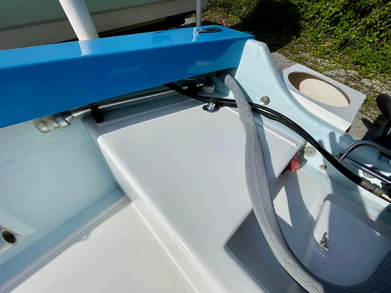 Slide: The Image of Close-up of a 1979 Negus 17 boat interior, featuring blue and white components. - 11