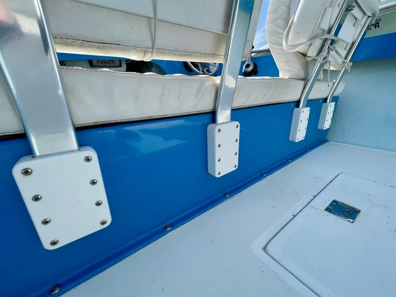 Slide: The Image of Interior of a 1979 Negus 17 boat, featuring blue and white seating. - 12