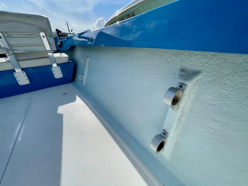 Slide: The Image of 1979 Negus 17 boat interior with blue and white seating and rod holders. - 13
