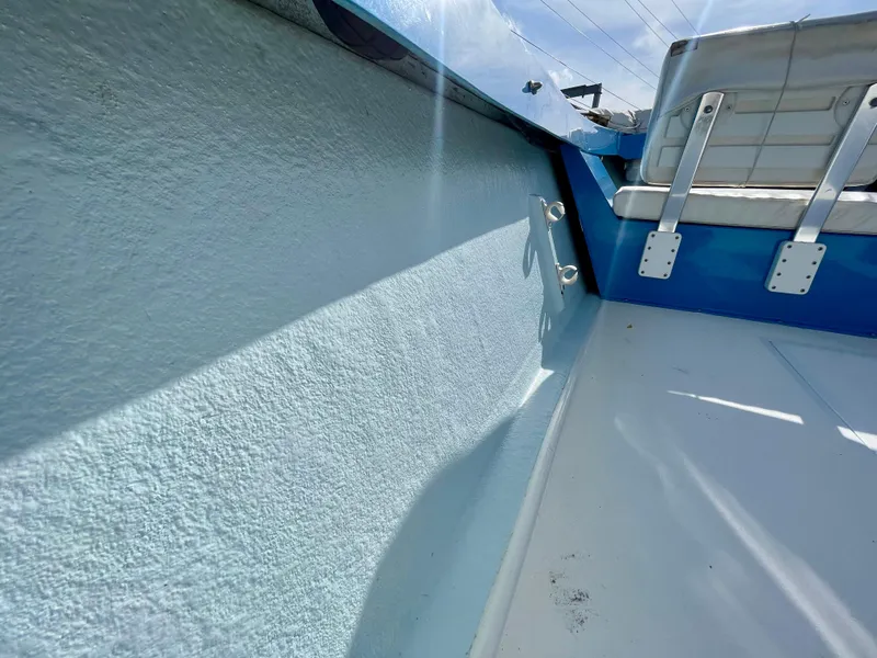 Slide: The Image of Interior view of a 1979 Negus 17 boat, showcasing seating and side details. - 14